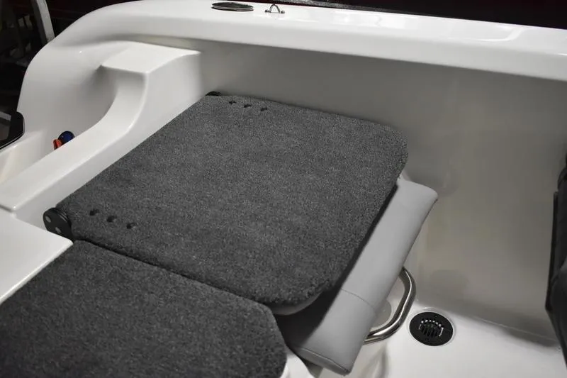 Slide: The Image of 2024 Triton 186 Allure boat interior with cushioned seating and storage compartment. - 123