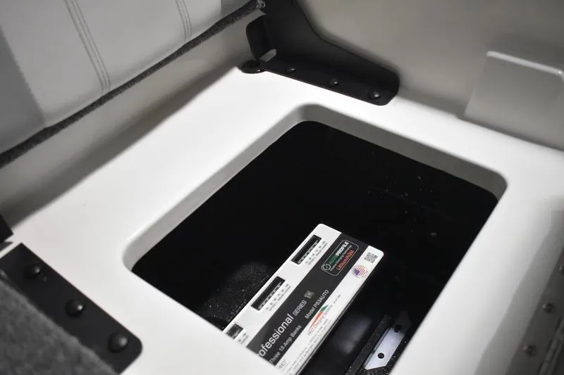 Slide: The Image of 2024 Triton 186 Allure boat storage compartment with battery inside. - 125