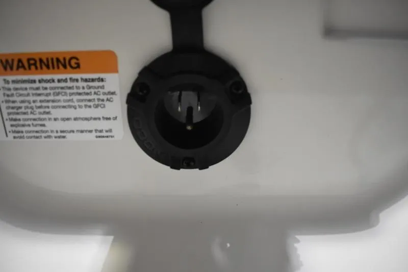 Slide: The Image of Close-up of a 2024 Triton 186 Allure warning label and electrical socket. - 126