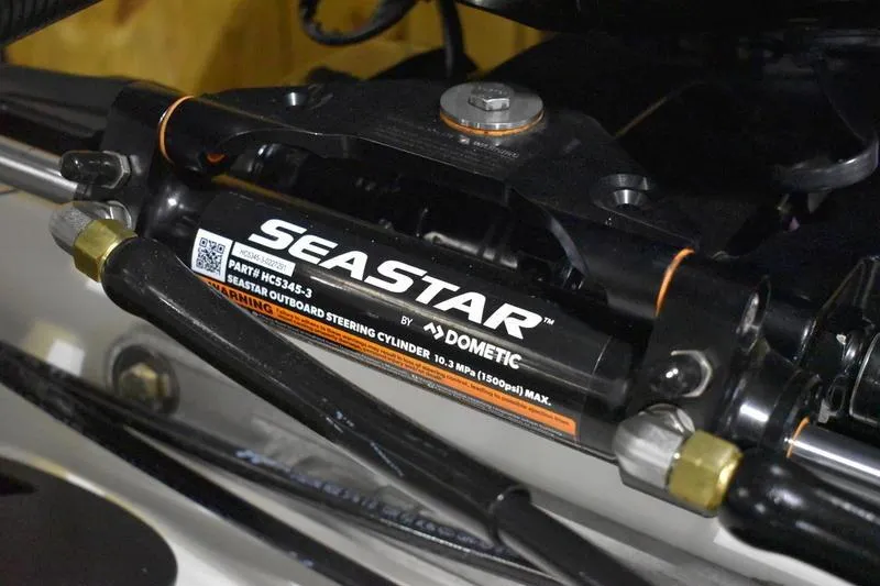 Slide: The Image of Close-up of SeaStar outboard steering cylinder on 2024 Triton 186 Allure boat. - 130