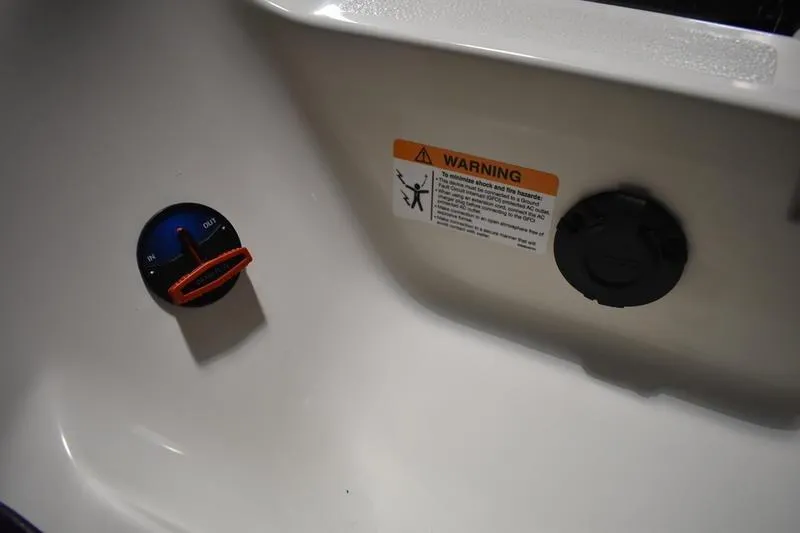 Slide: The Image of Control panel and warning label on 2024 Triton 186 Allure boat interior. - 133