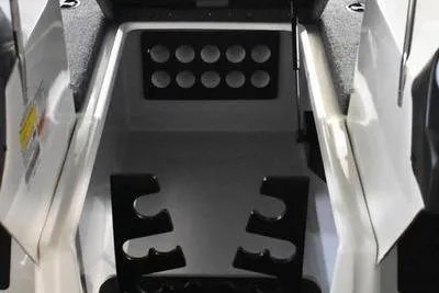 Slide: The Image of 2024 Triton 186 Allure boat interior with rod holders and storage compartments. - 19