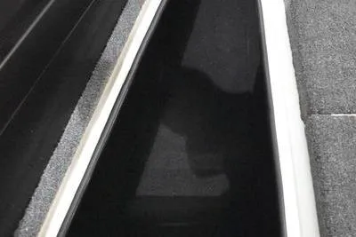 Slide: The Image of 2024 Triton 186 Allure boat interior, featuring carpeted steps and storage compartments. - 20