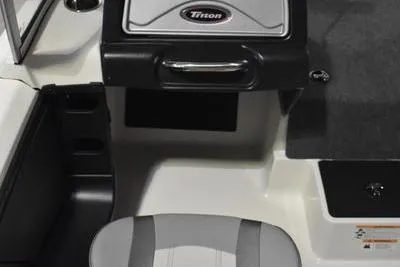 Slide: The Image of 2024 Triton 186 Allure boat storage compartment with carpeted interior. - 24