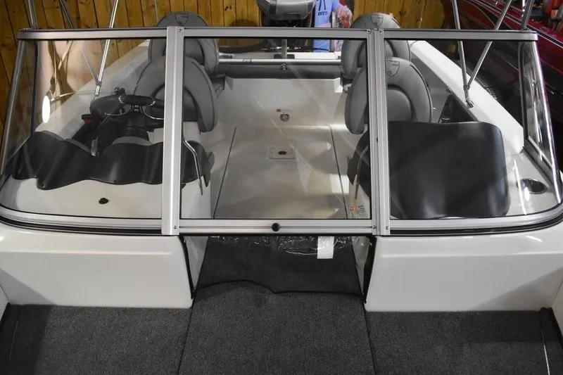 Slide: The Image of 2024 Triton 186 Allure boat interior with carpeted flooring and seating area. - 26