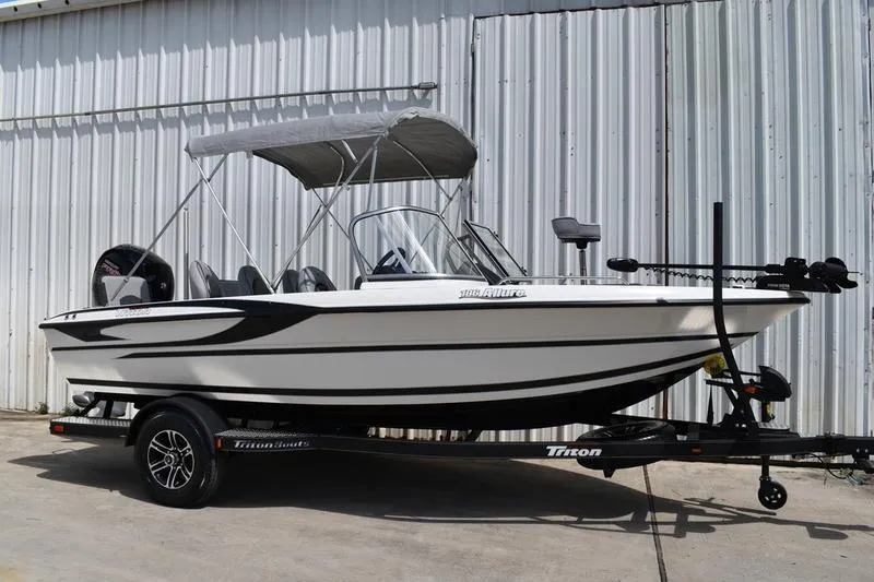 Slide: The Image of 2024 Triton 186 Allure boat interior with windshield and console detail. - 33