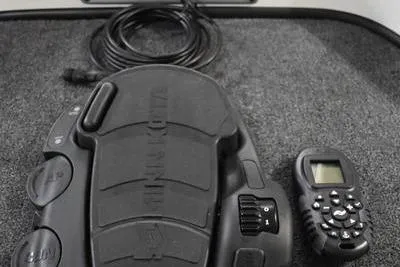 Slide: The Image of 2024 Triton 186 Allure boat control panel with switches and throttle lever. - 41