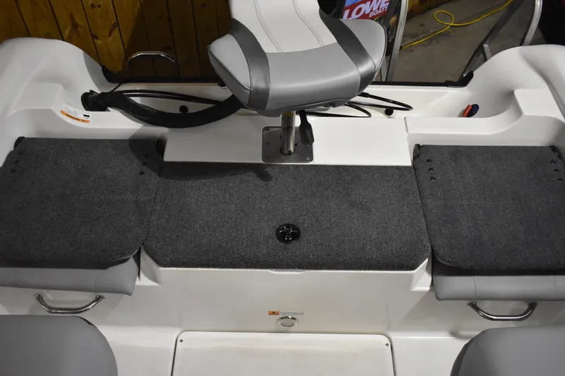 Slide: The Image of 2024 Triton 186 Allure boat interior with gray seating and carpeted flooring. - 56