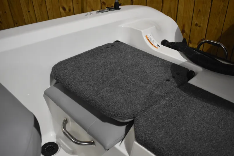 Slide: The Image of 2024 Triton 186 Allure boat interior with cushioned seating and storage handle. - 58