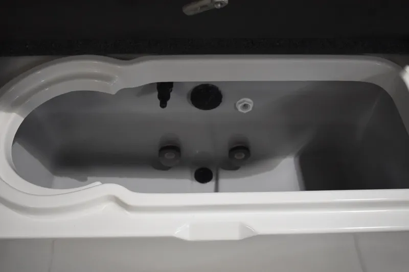 Slide: The Image of 2024 Triton 186 Allure boat livewell interior, featuring a sleek, white design. - 64