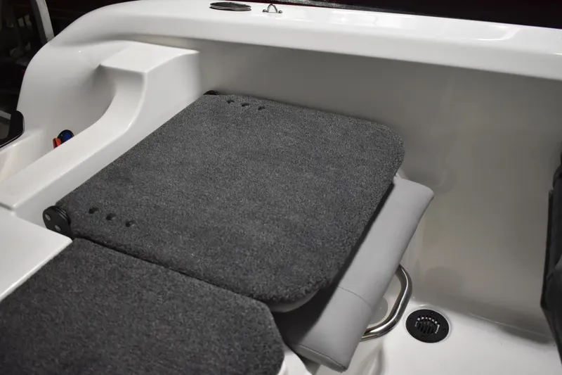Slide: The Image of 2024 Triton 186 Allure boat interior with cushioned seating and storage area. - 66