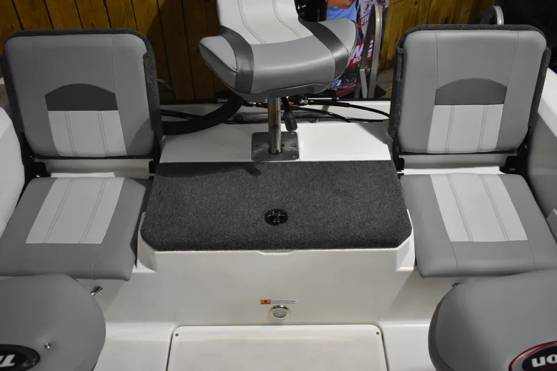 Slide: The Image of 2024 Triton 186 Allure boat interior with gray seating and central swivel chair. - 70