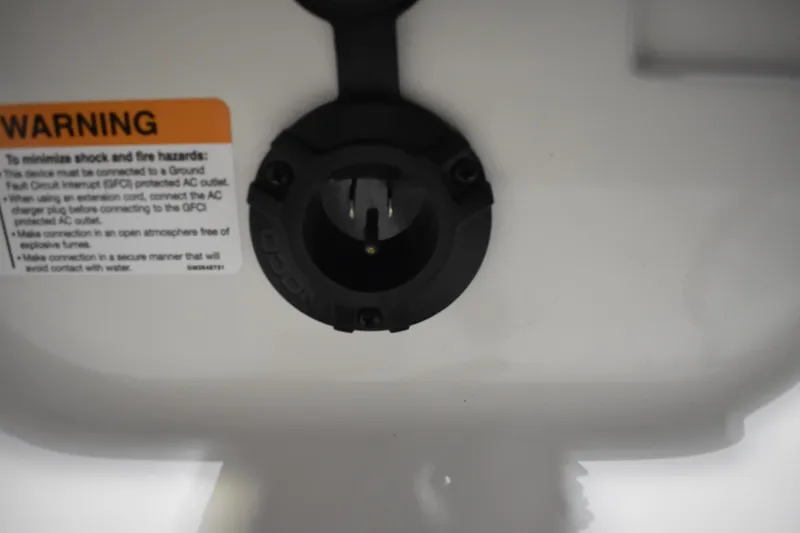 Slide: The Image of Close-up of a 2024 Triton 186 Allure warning label and electrical outlet. - 76
