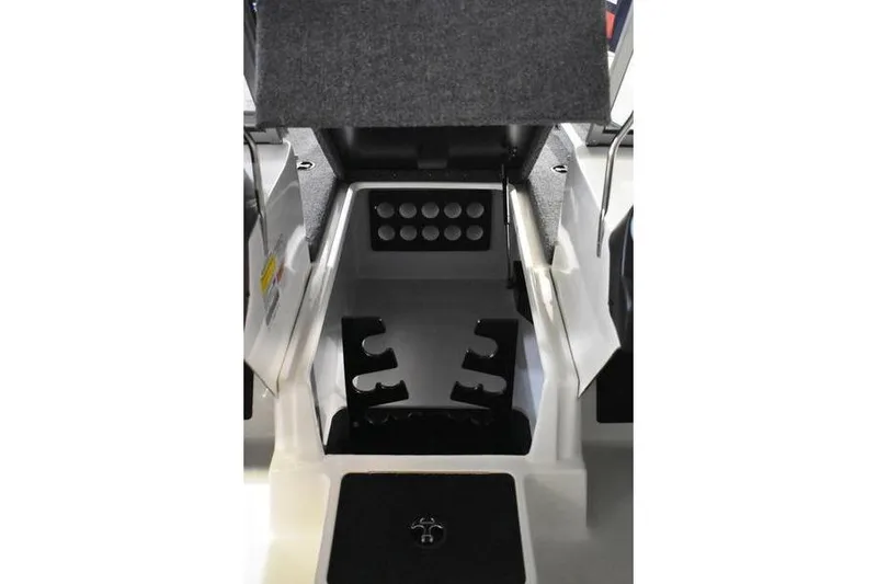 Slide: The Image of 2024 Triton 186 Allure boat interior storage compartment with rod holders and carpeted lid. - 78