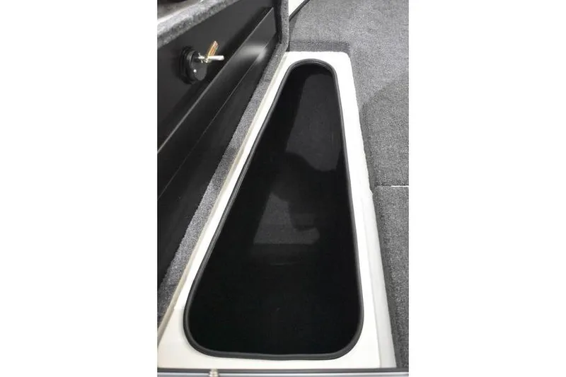 Slide: The Image of 2024 Triton 186 Allure boat storage compartment with carpeted interior and secure latch. - 80