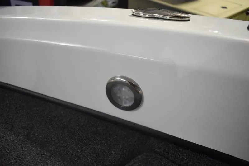 Slide: The Image of 2024 Triton 186 Allure boat interior detail with sleek white finish and circular light fixture. - 85