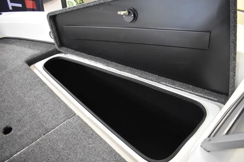 Slide: The Image of 2024 Triton 186 Allure boat storage compartment with open lid, showcasing spacious interior. - 86