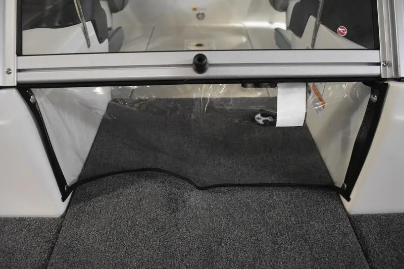 Slide: The Image of 2024 Triton 186 Allure boat interior with carpeted flooring and seating area. - 88