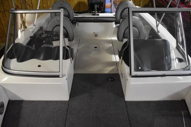 Slide: The Image of 2024 Triton 186 Allure boat interior with dual consoles and seating. - 90