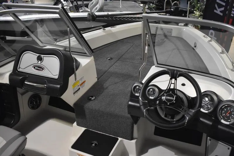Slide: The Image of 2024 Triton 186 Allure boat interior with steering wheel and dashboard. - 92