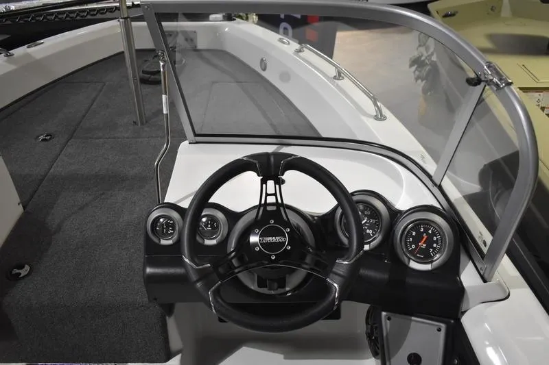 Slide: The Image of 2024 Triton 186 Allure boat dashboard with steering wheel and gauges. - 95