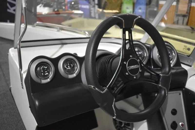 Slide: The Image of 2024 Triton 186 Allure boat dashboard with steering wheel and gauges. - 96