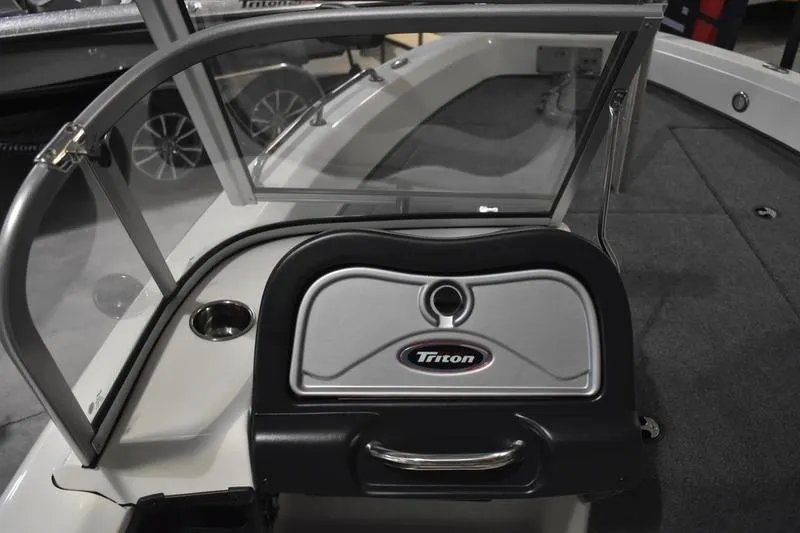 Slide: The Image of 2024 Triton 186 Allure boat interior with windshield and storage compartment. - 99