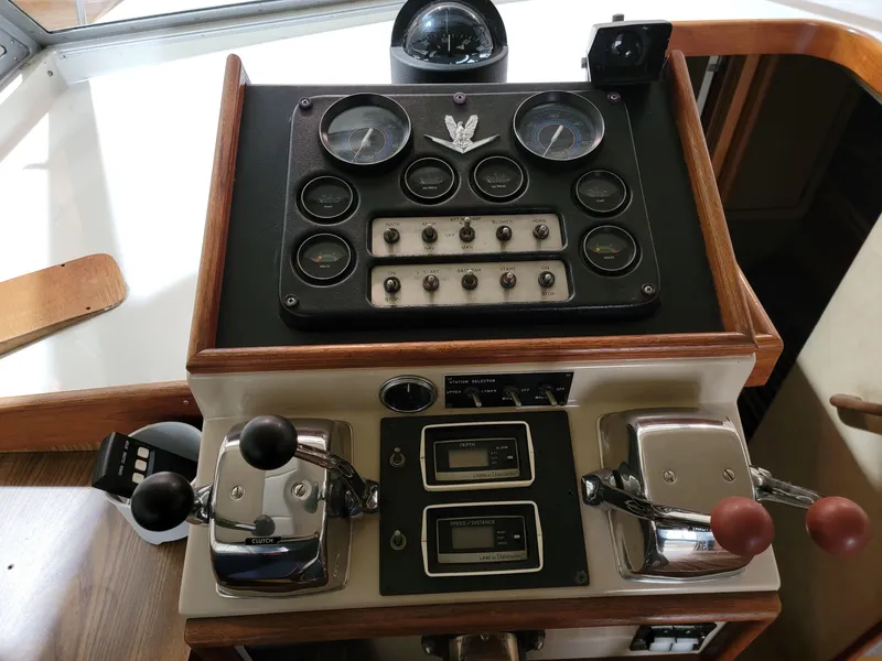 Slide: The Image of Control panel of a 1983 Bertram 33 Flybridge Cruiser with gauges and levers. - 16