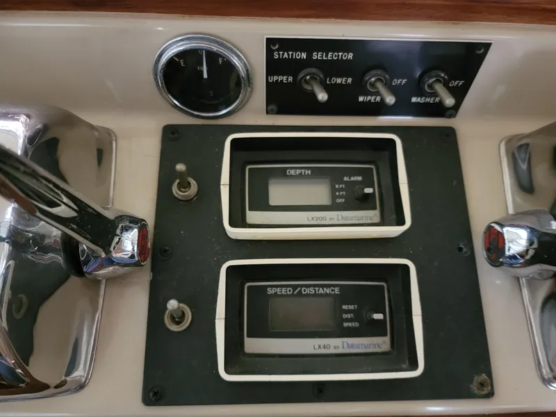 Slide: The Image of 1983 Bertram 33 Flybridge Cruiser dashboard with depth and speed gauges. - 17