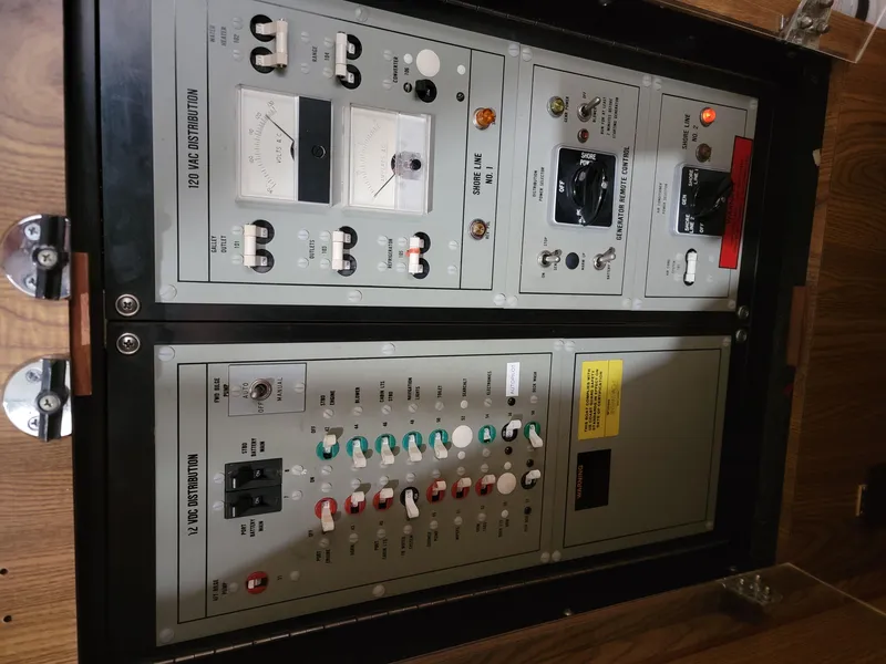 Slide: The Image of Control panel of a 1983 Bertram 33 Flybridge Cruiser, featuring various switches and gauges. - 22