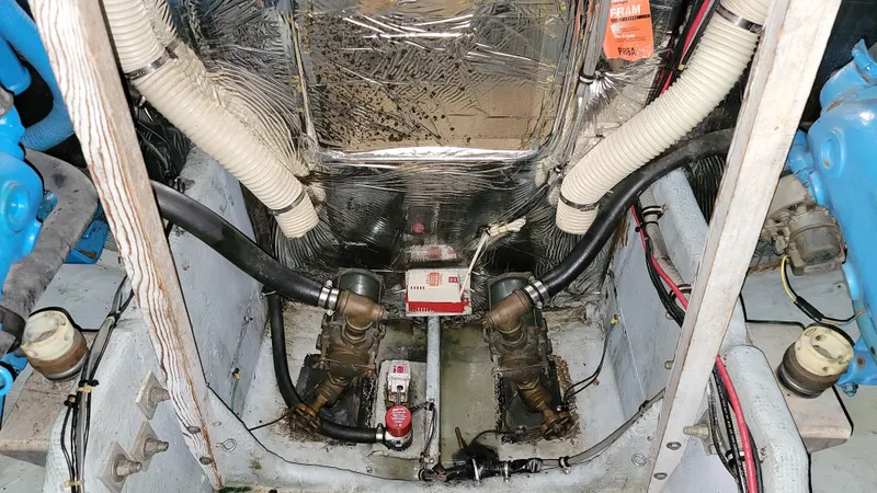 Slide: The Image of Engine compartment of a 1983 Bertram 33 Flybridge Cruiser with visible components and wiring. - 32