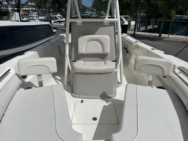 Slide: The Image of 2022 Sea Born 22 LX boat interior with white seating and storage compartments. - 2