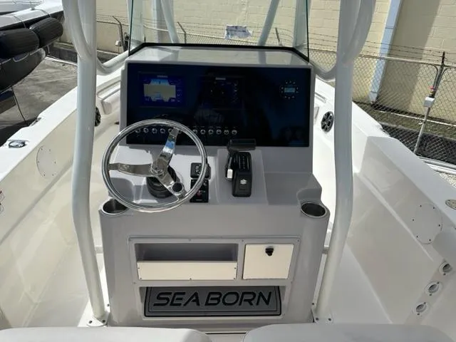 Slide: The Image of 2022 Sea Born 22 LX boat console with steering wheel and navigation system. - 8