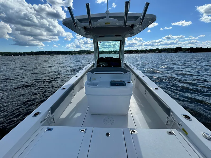 Slide: The Image of 2024 Everglades 273 Center Console boat on open water under a blue sky. - 12