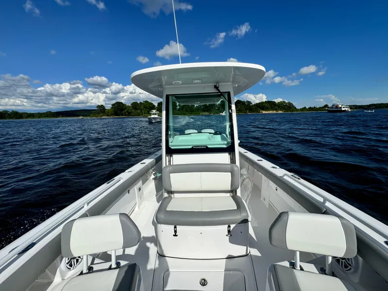 Slide: The Image of 2024 Everglades 273 Center Console boat on open water with clear blue sky. - 19