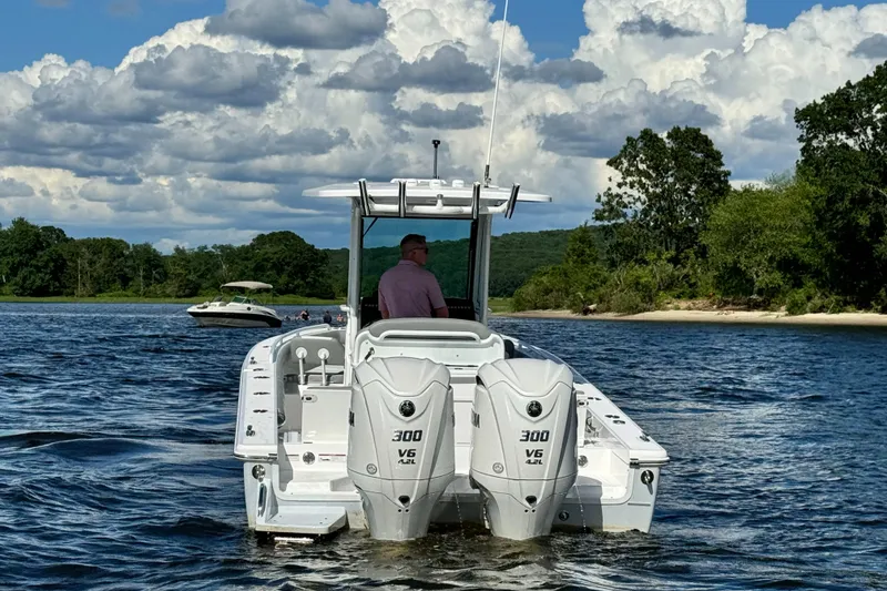Slide: The Image of 2024 Everglades 273 Center Console boat on water with twin 300 V6 engines. - 4