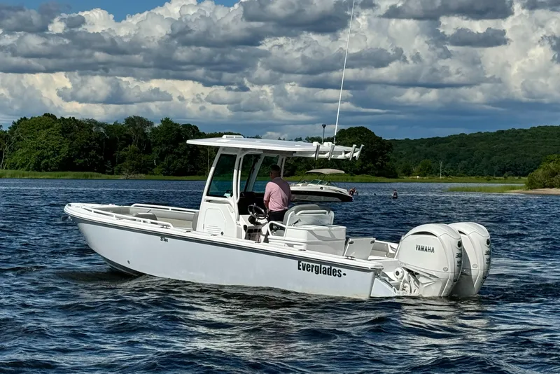Slide: The Image of 2024 Everglades 273 Center Console boat on a lake with scenic background. - 6