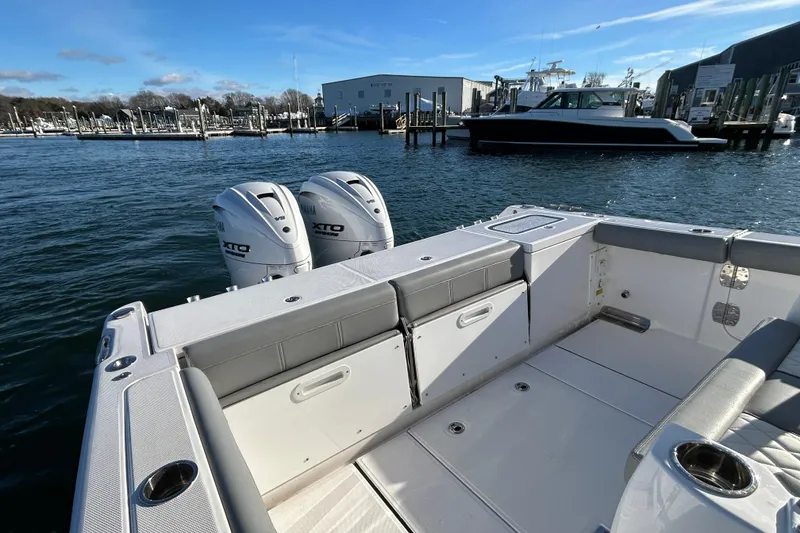 Slide: The Image of 2024 Everglades 335 Center Console boat with dual engines docked at marina. - 15