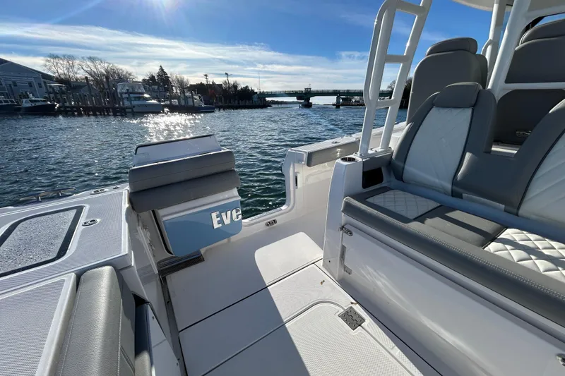 Slide: The Image of 2024 Everglades 335 Center Console boat interior with luxurious seating and scenic waterfront view. - 18