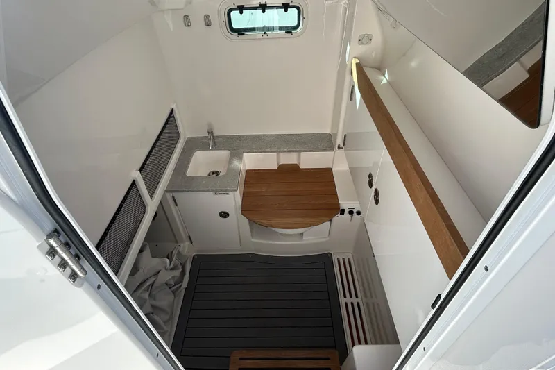 Slide: The Image of 2024 Everglades 335 Center Console interior with sink, wooden accents, and modern design. - 20