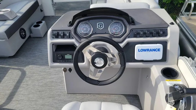 Slide: The Image of 2023 Godfrey Sweetwater 2086 BF GTP 27 in. Center Tube boat dashboard with steering wheel and Lowrance system. - 12