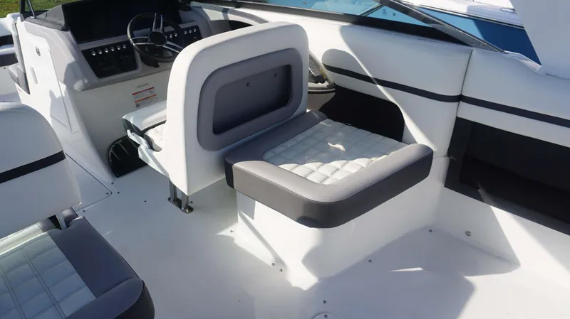 Slide: The Image of 2024 Cobalt 30 SC boat interior with modern seating and steering console. - 11