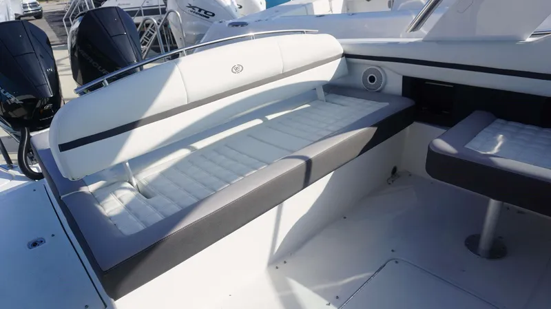 Slide: The Image of 2024 Cobalt 30 SC boat interior with white cushioned seating and modern design. - 12