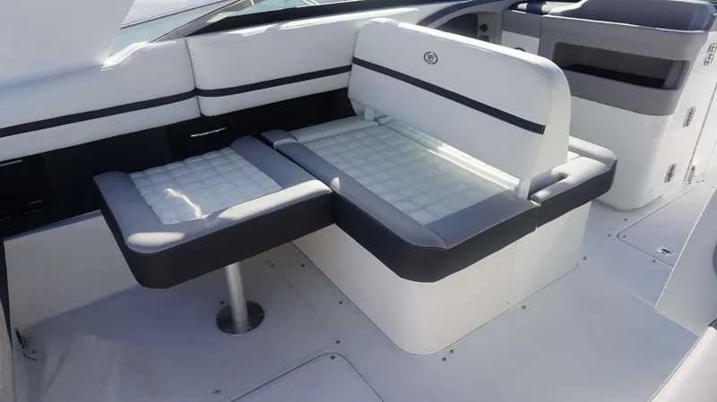 Slide: The Image of 2024 Cobalt 30 SC boat interior with white and gray seating. - 13