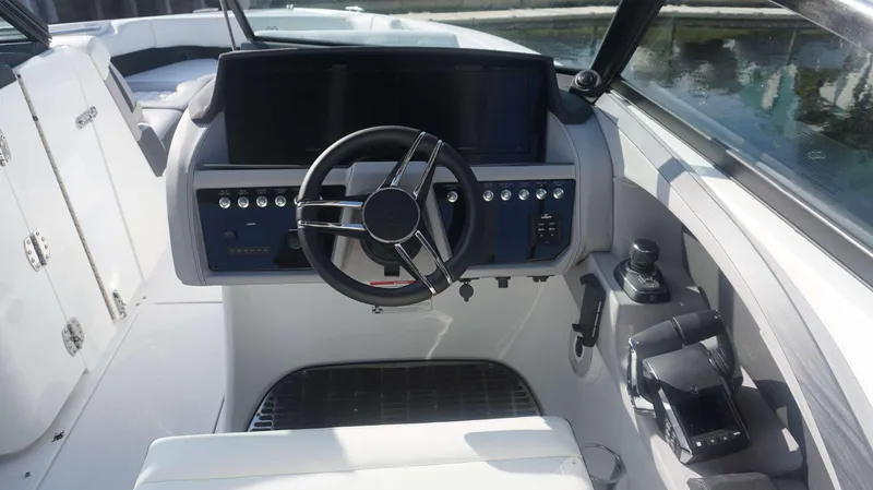 Slide: The Image of 2024 Cobalt 30 SC boat helm with modern controls and steering wheel. - 14
