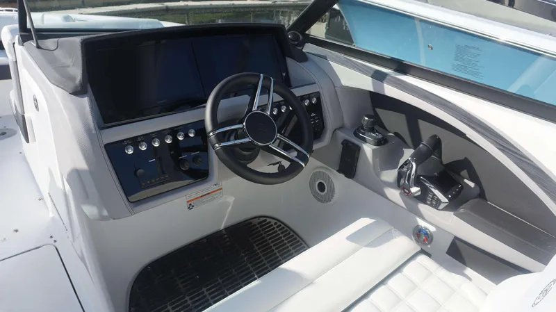 Slide: The Image of 2024 Cobalt 30 SC boat cockpit with modern steering and controls. - 15