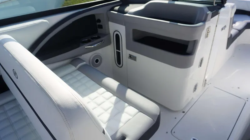 Slide: The Image of 2024 Cobalt 30 SC boat interior with white and gray seating. - 16