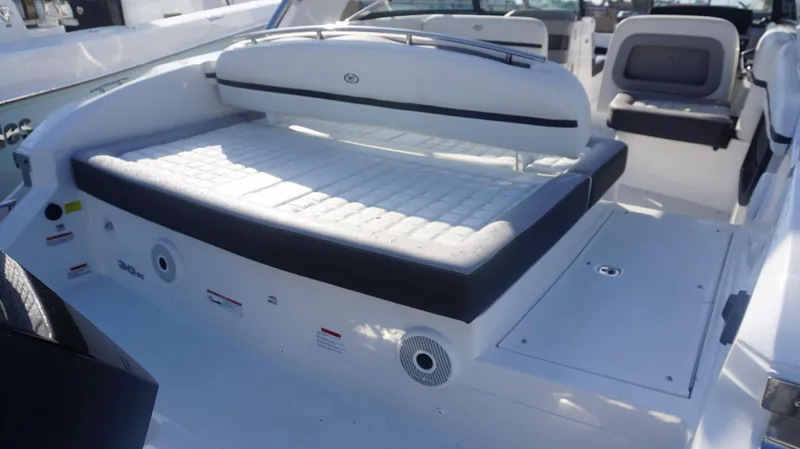 Slide: The Image of 2024 Cobalt 30 SC boat interior with cushioned seating and sleek design. - 18