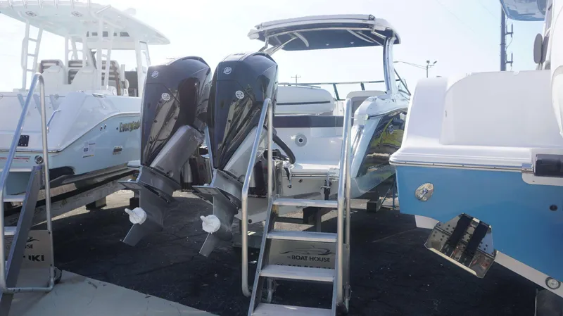 Slide: The Image of 2024 Cobalt 30 SC boat with dual outboard engines, docked at a marina. - 3