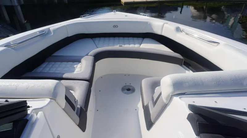 Slide: The Image of 2024 Cobalt 30 SC boat interior with cushioned seating and sleek design. - 6